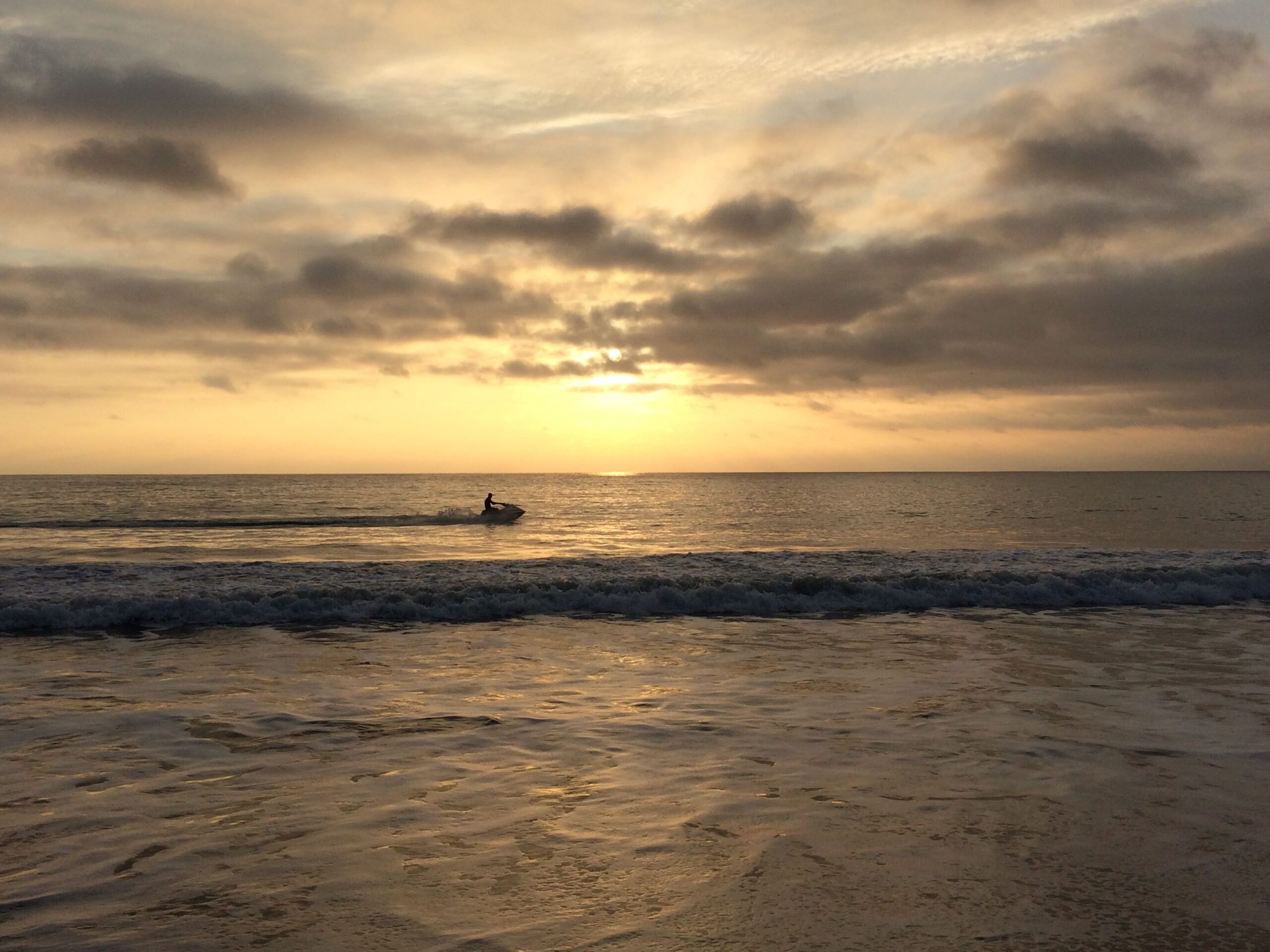 Single Jet Ski on the ocean under beautiful setting sun