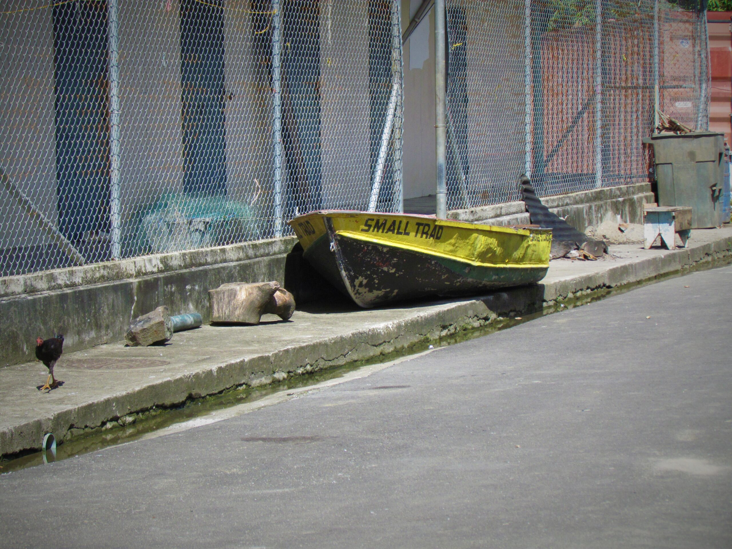 An old fishing boat abandoned on the side of the road