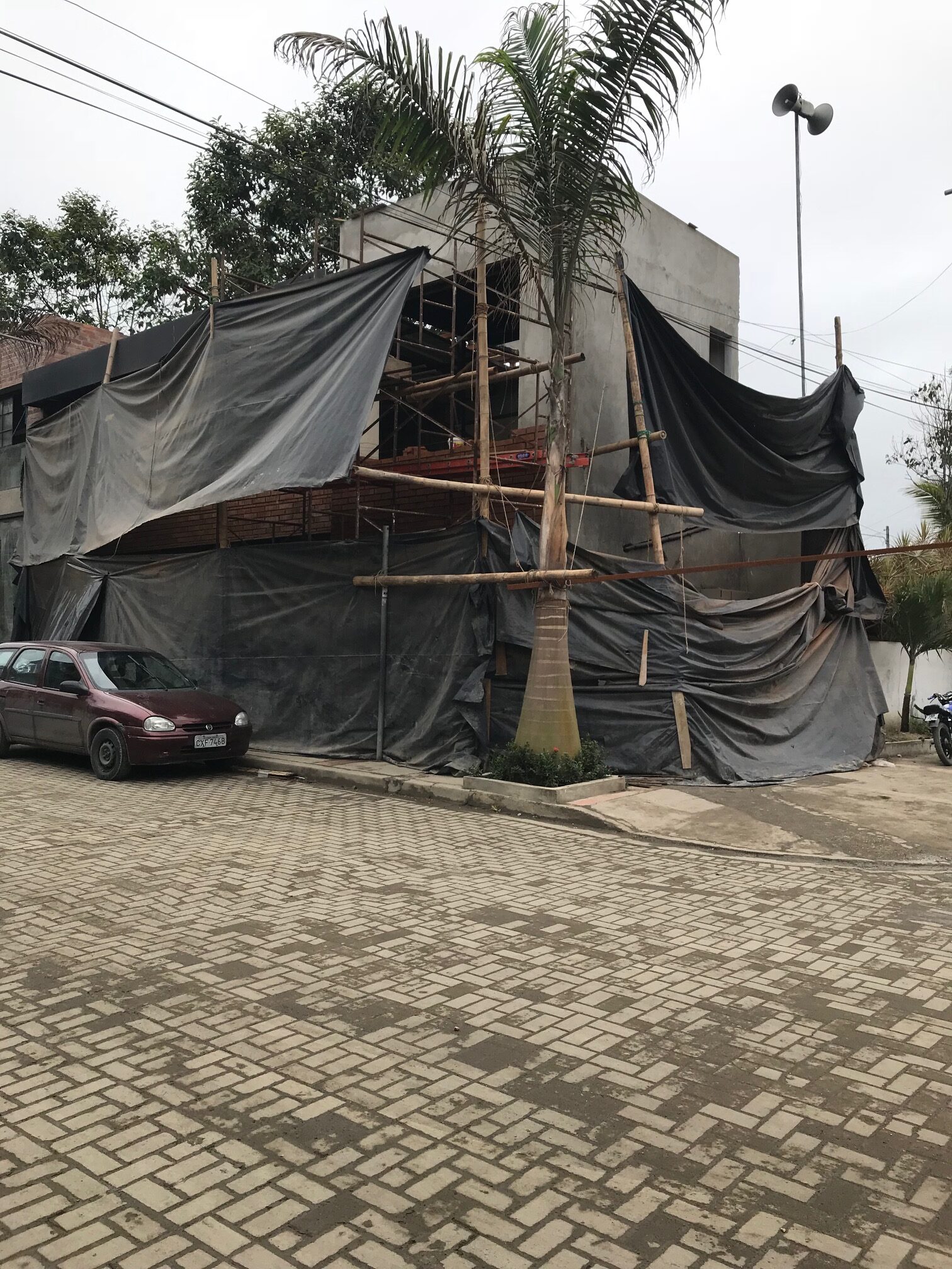 A building damaged by an earthquake and covered with tarps.