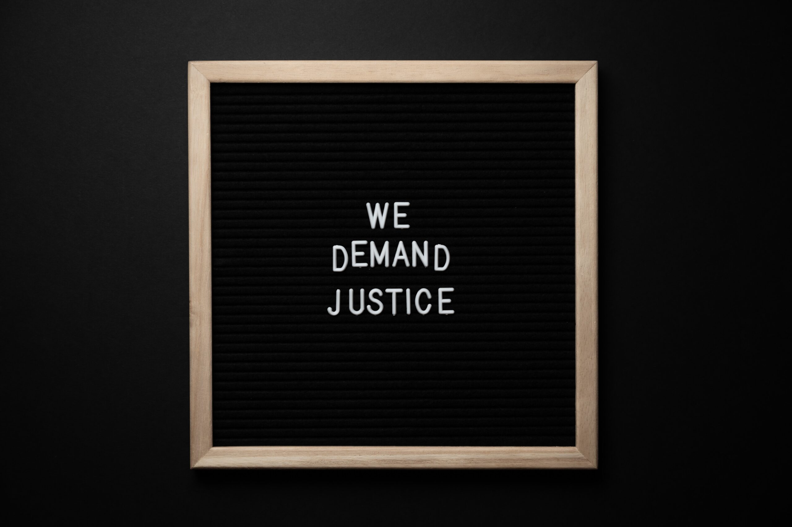 Framed Image of a sign saying "We Demand Justice"