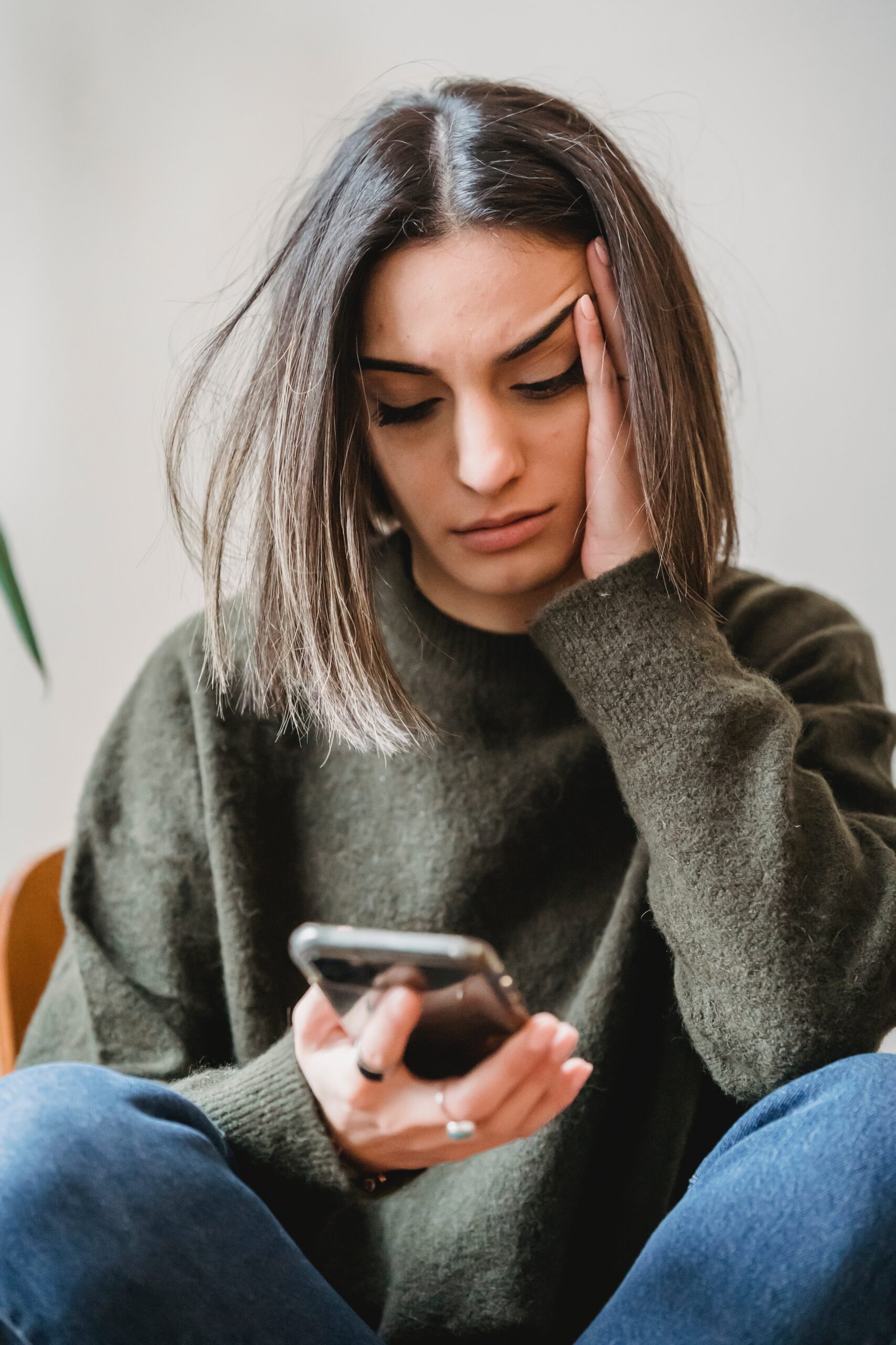 Concerned woman looking at phone.