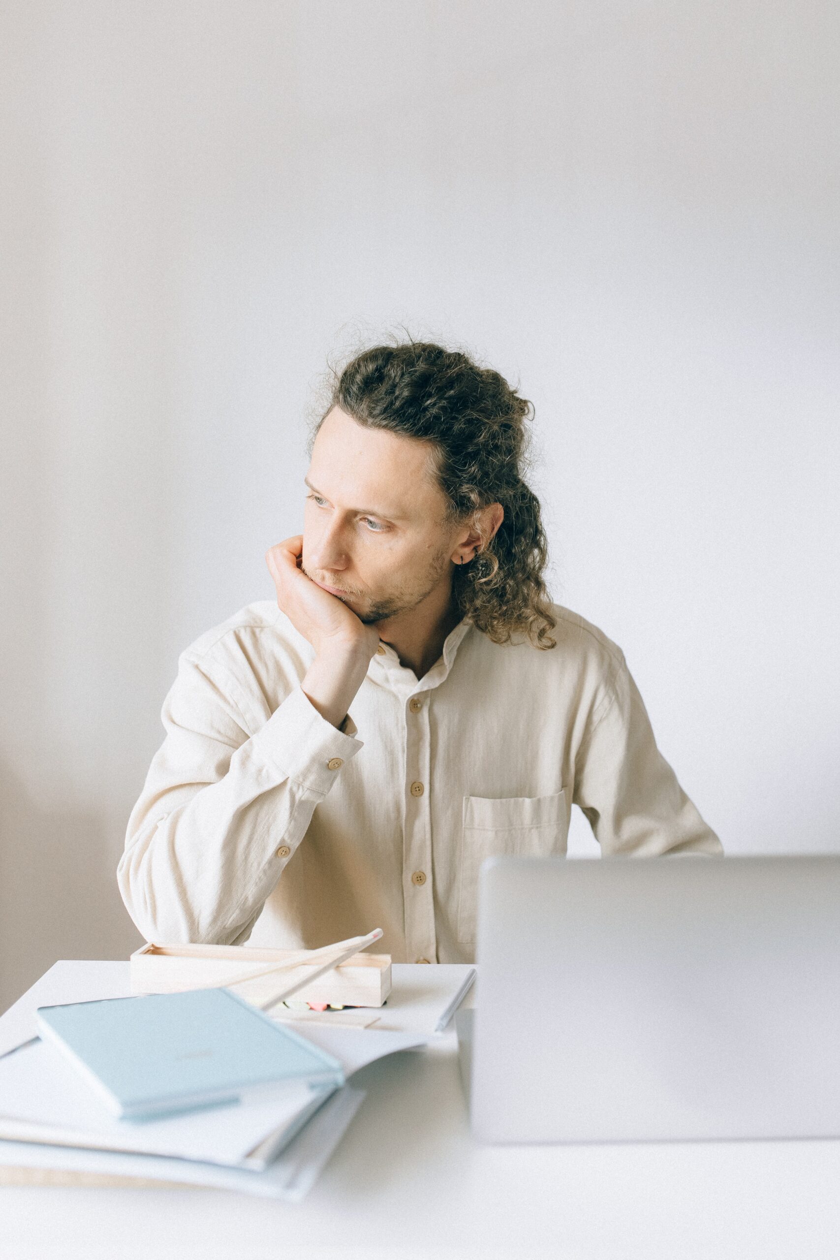 Man sitting at computer looking stressed.