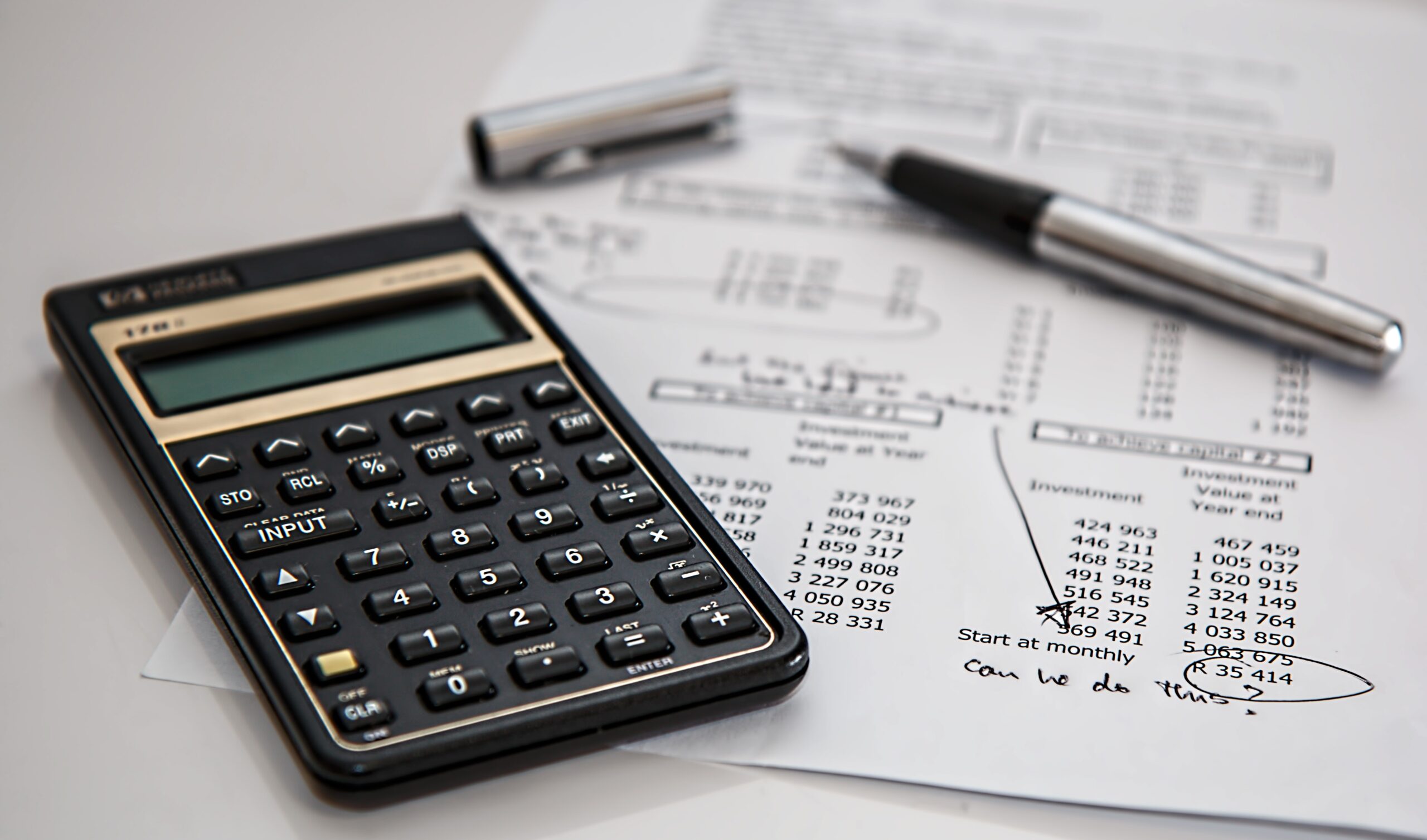 calculator and pen on a page of numbers