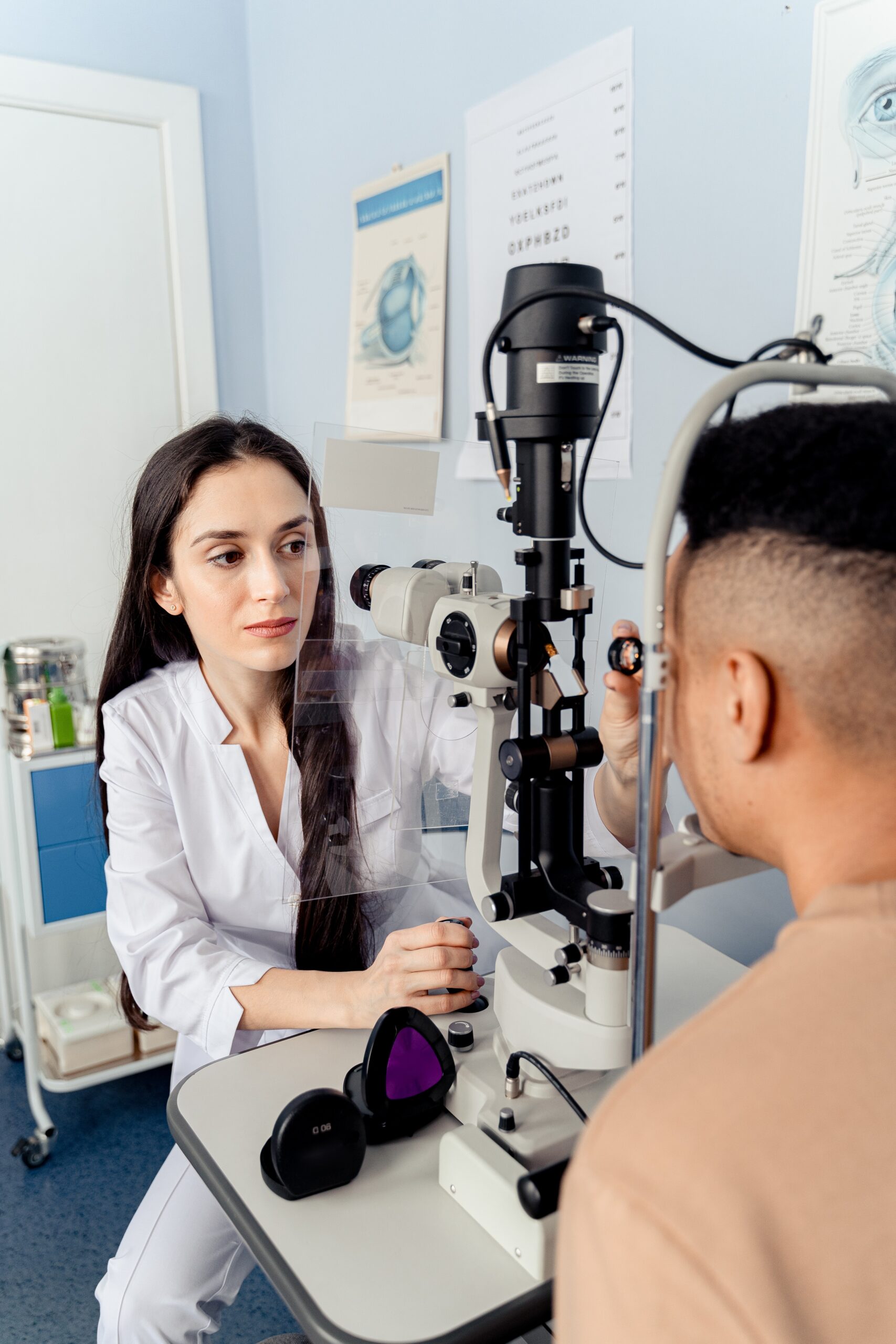 Optometrist treating patient