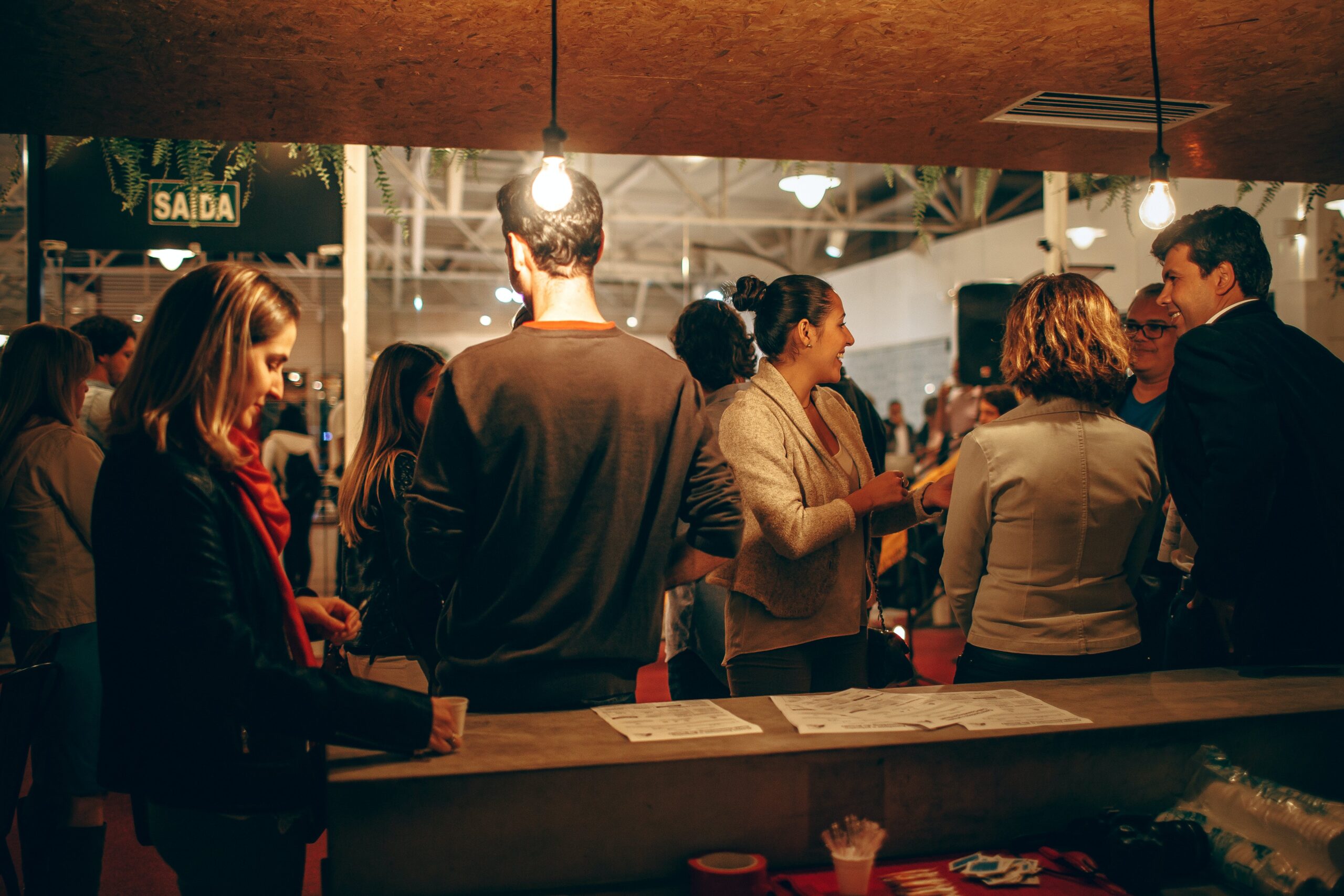 People mingling at a bar.