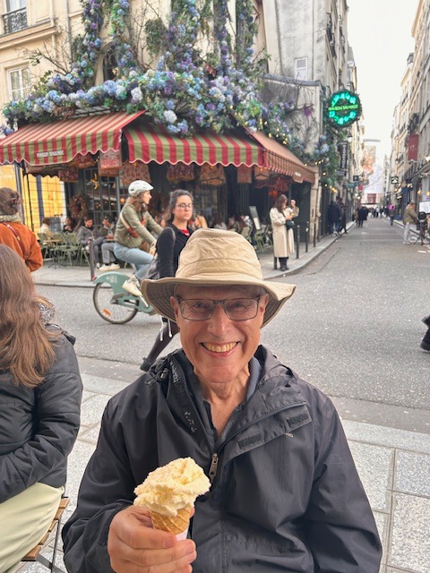 A photo of the author eating an icecream in Paris.