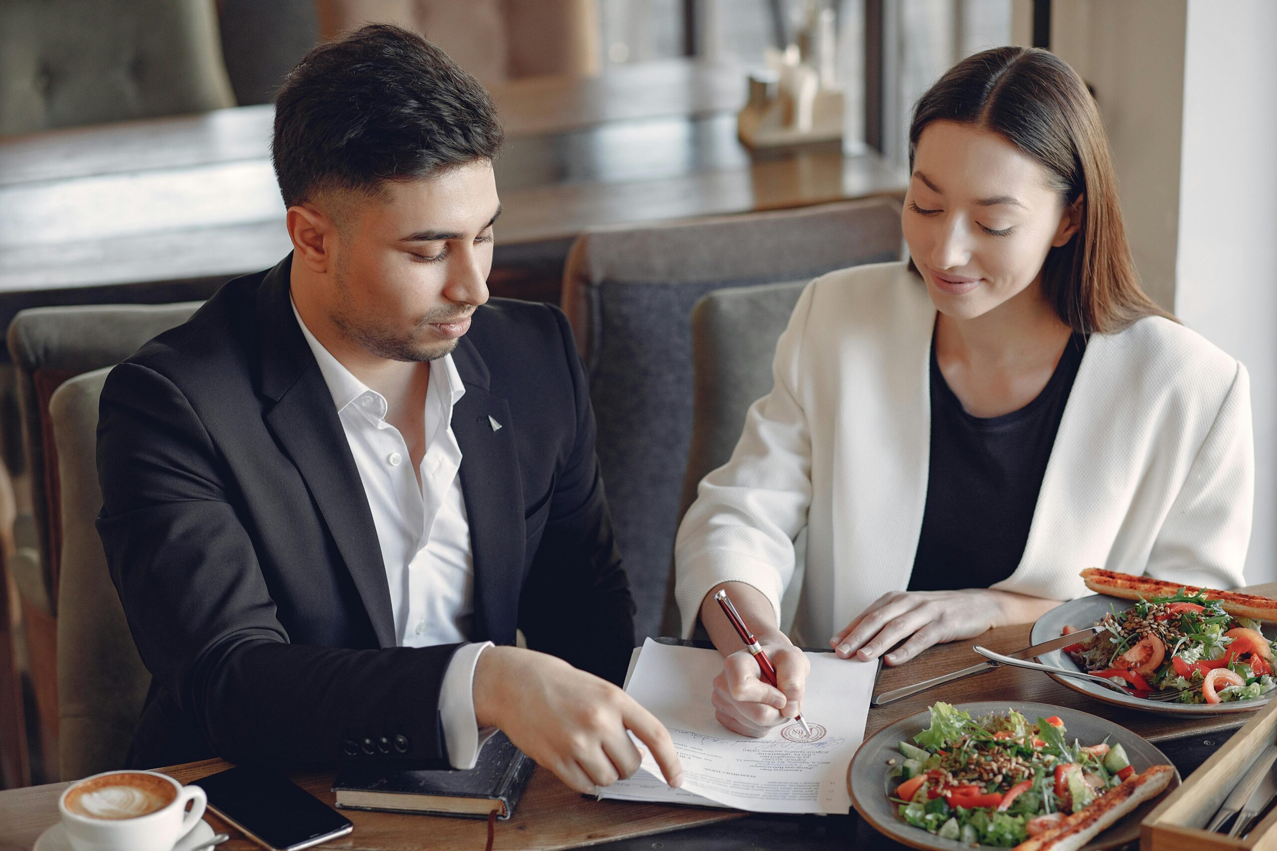 A man and a woman having a business lunch.