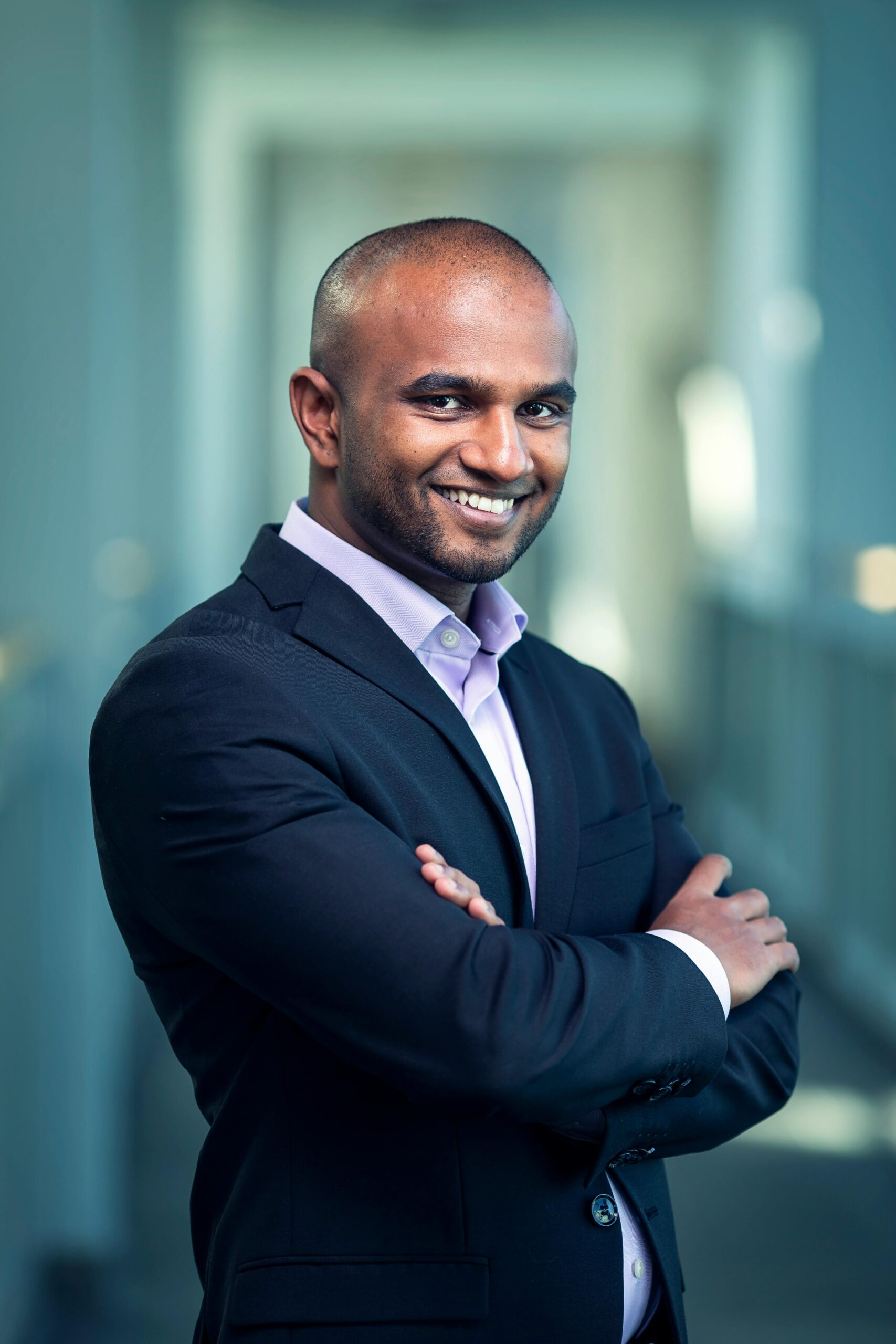 Confident looking man formally dressed with his arms folded.