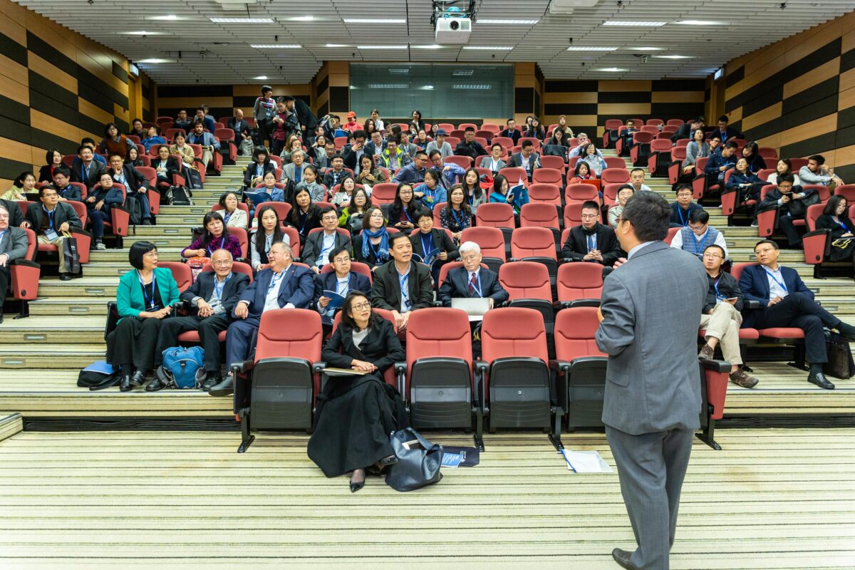 A professor in front of a large class.