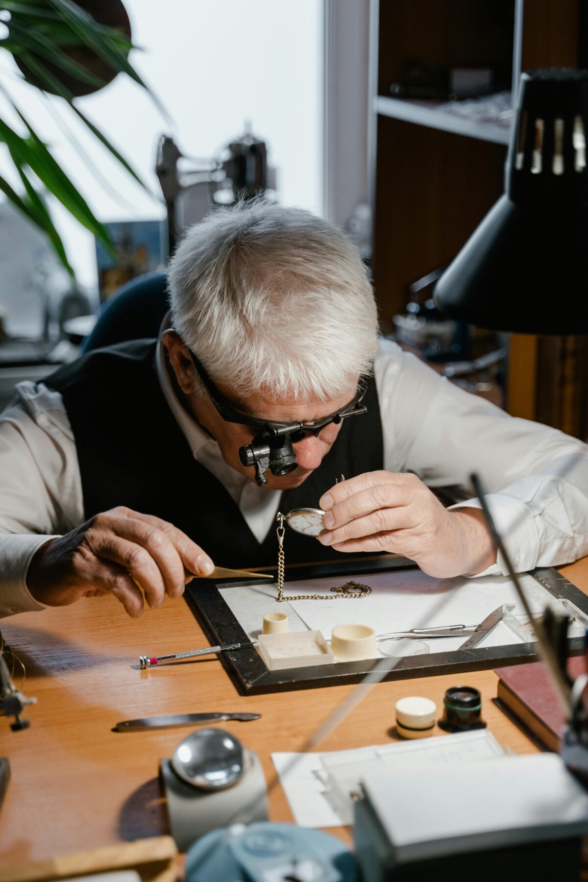 A watchmaker looking at a time piece.