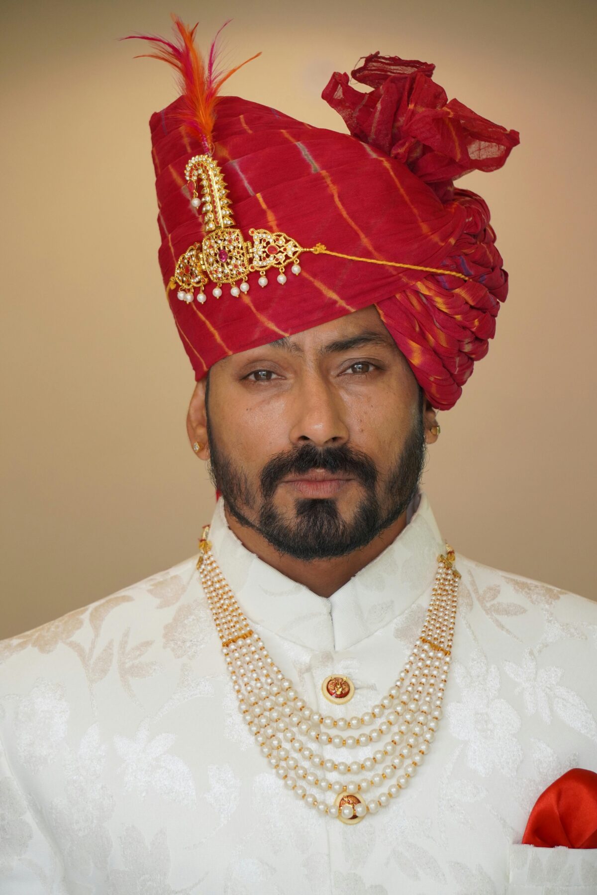 A wealthy looking man wearing a ceremonial turban.